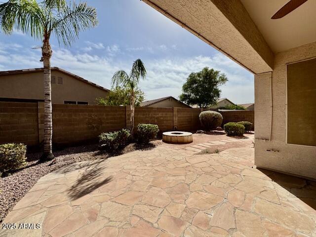 view of patio with a fenced backyard and a ceiling fan