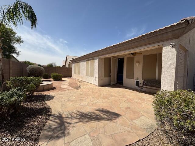 exterior space with a patio area, a fenced backyard, and stucco siding