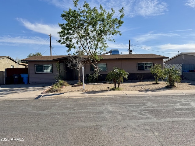 single story home with concrete driveway