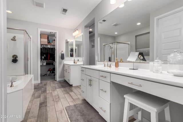 bathroom featuring vanity and separate shower and tub