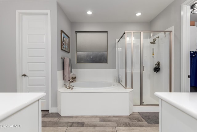 bathroom featuring vanity and independent shower and bath