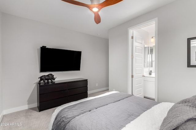 carpeted bedroom with ceiling fan and connected bathroom