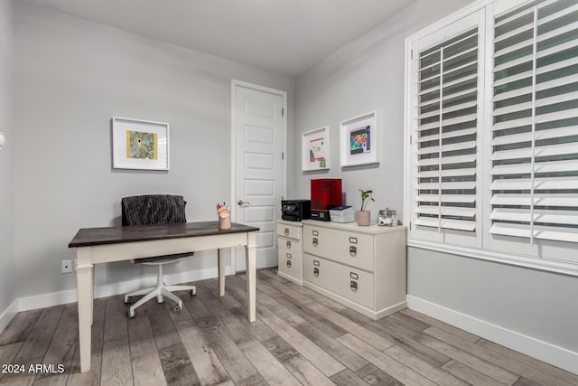 office with light wood-type flooring