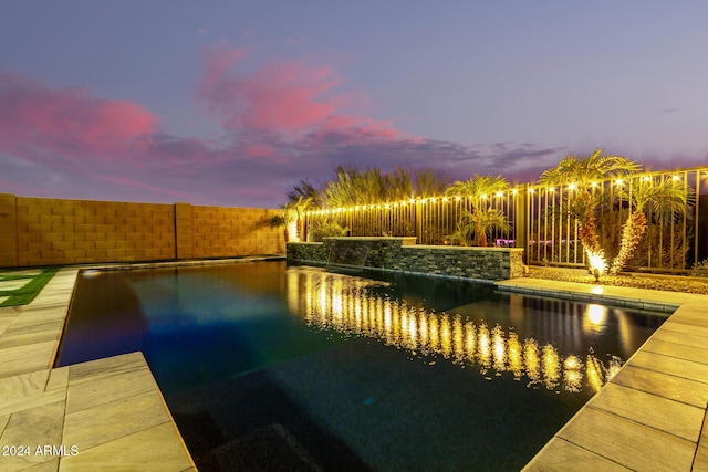 view of pool at dusk