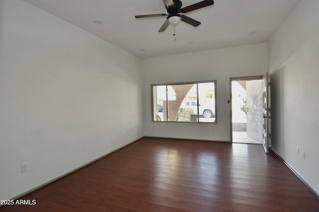 unfurnished room with dark hardwood / wood-style flooring and ceiling fan