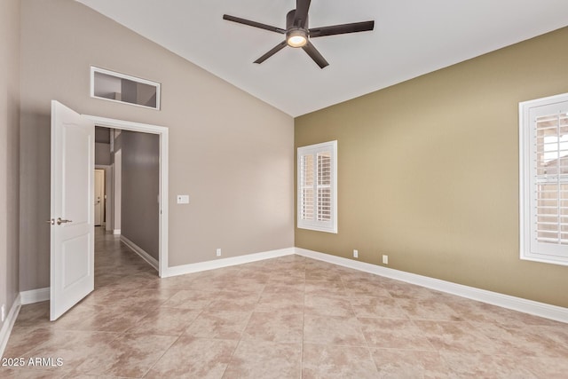 empty room with light tile patterned floors, ceiling fan, high vaulted ceiling, and baseboards