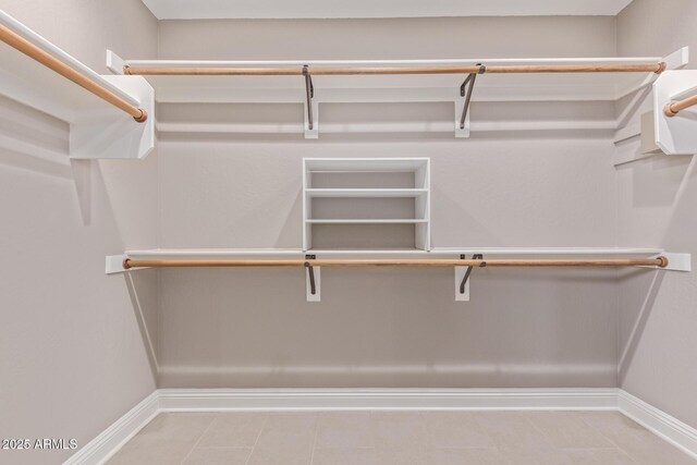 spacious closet with tile patterned floors