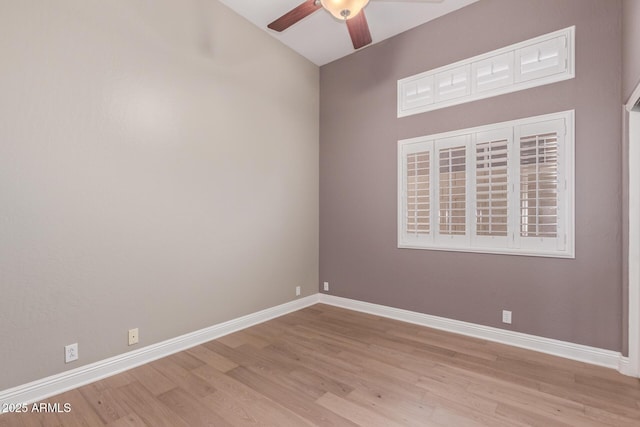 empty room with ceiling fan, wood finished floors, and baseboards