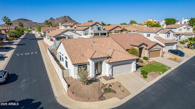 birds eye view of property with a mountain view and a residential view