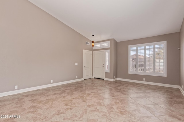 entrance foyer with visible vents, baseboards, and vaulted ceiling