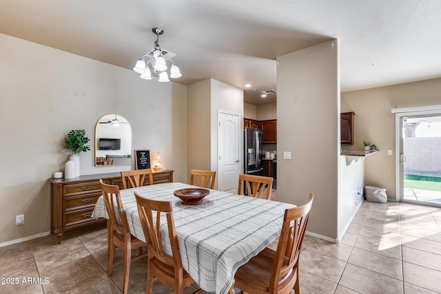 dining space featuring light tile patterned floors, a chandelier, visible vents, and baseboards