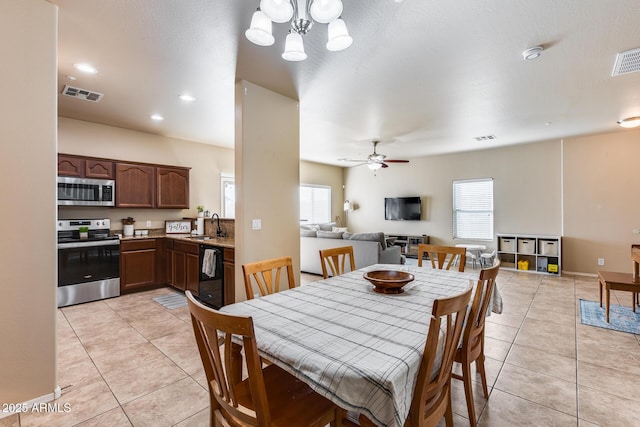 dining room featuring light tile patterned floors, visible vents, and a healthy amount of sunlight