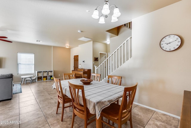 dining area with light tile patterned floors, stairway, visible vents, and baseboards