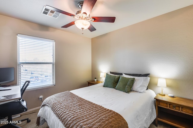 bedroom featuring ceiling fan, carpet, visible vents, and baseboards