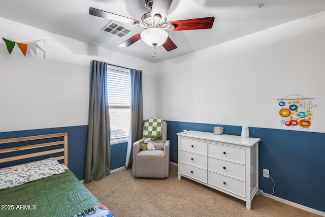 bedroom featuring baseboards, visible vents, ceiling fan, and light colored carpet