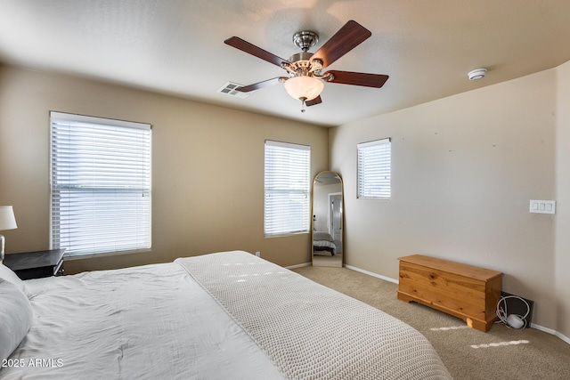 bedroom featuring ceiling fan, carpet flooring, visible vents, and baseboards