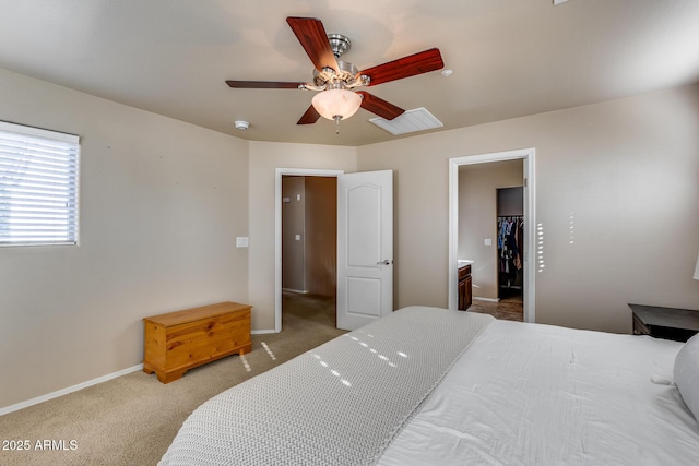 carpeted bedroom with baseboards, visible vents, a ceiling fan, a spacious closet, and a closet