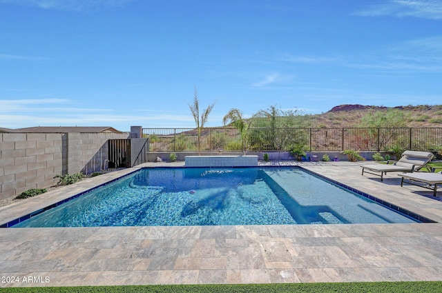 view of pool featuring pool water feature and a patio