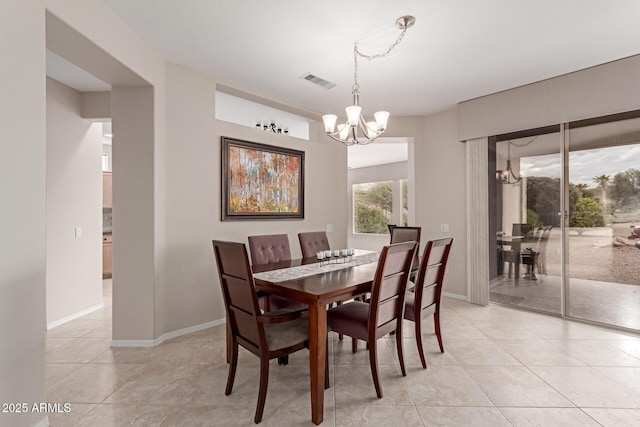 dining room with light tile patterned floors, visible vents, baseboards, and an inviting chandelier