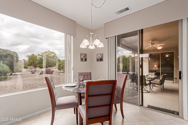 dining room with light tile patterned floors, visible vents, and ceiling fan with notable chandelier