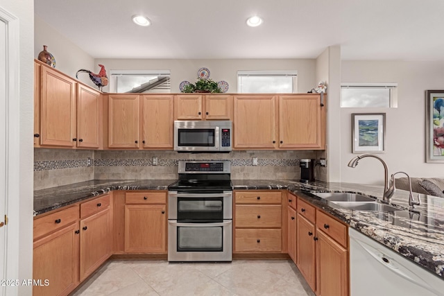 kitchen with recessed lighting, backsplash, stainless steel appliances, and a sink