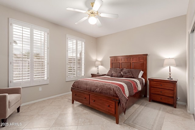 bedroom with light tile patterned flooring, baseboards, and ceiling fan