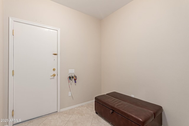 interior space featuring light tile patterned flooring and baseboards