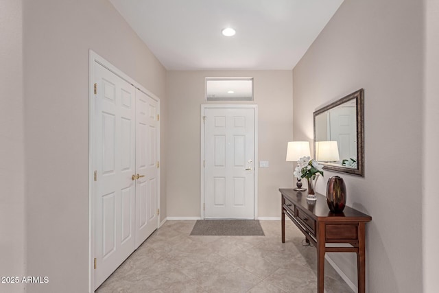 foyer entrance featuring baseboards