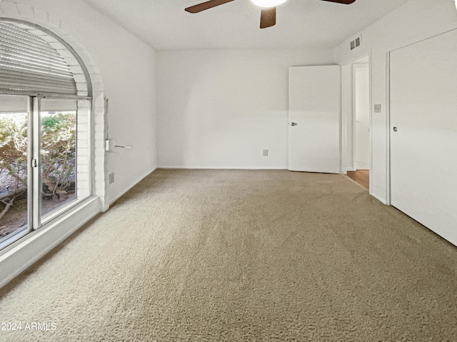 spare room featuring ceiling fan and carpet floors