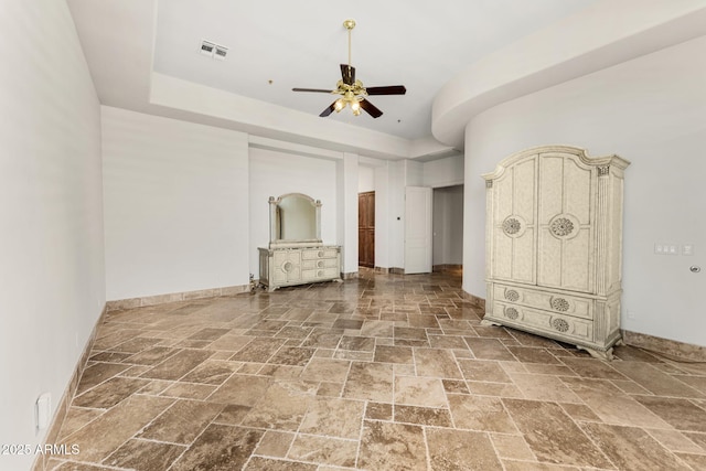 11986 N 134th Pl, Scottsdale, AZ 85259 - unfurnished bedroom featuring stone tile floors, a ceiling fan, and baseboards