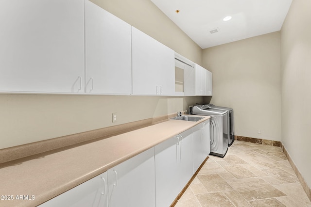 11986 N 134th Pl, Scottsdale, AZ 85259 - clothes washing area with cabinet space, stone tile flooring, washing machine and clothes dryer, and baseboards
