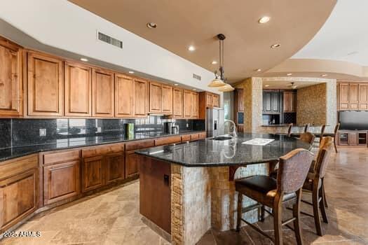 11986 N 134th Pl, Scottsdale, AZ 85259 - kitchen featuring brown cabinets, stainless steel fridge with ice dispenser, tasteful backsplash, and recessed lighting