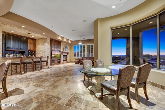 11986 N 134th Pl, Scottsdale, AZ 85259 - dining space featuring stone tile flooring, wet bar, and recessed lighting