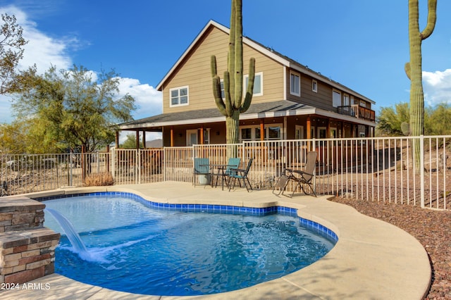 view of pool with a patio and pool water feature