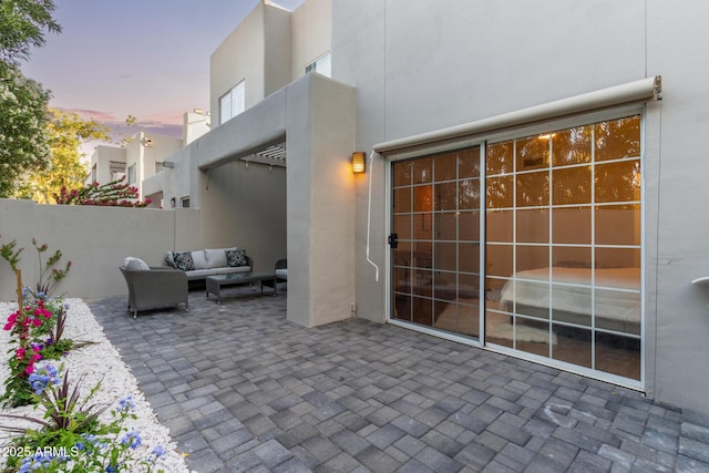 7710 E Gainey Ranch Rd Unit 142, Scottsdale, AZ 85258 - patio terrace at dusk featuring an outdoor hangout area and a patio area