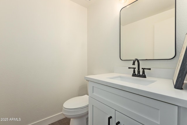 7710 E Gainey Ranch Rd Unit 142, Scottsdale, AZ 85258 - half bathroom featuring vanity, wood finished floors, baseboards, and toilet