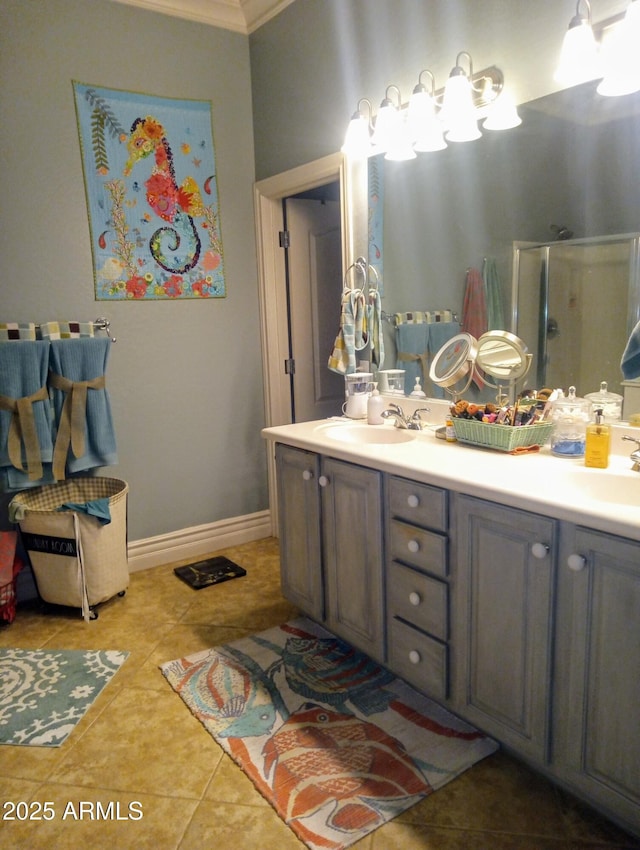 bathroom with double vanity, baseboards, a shower stall, and a sink