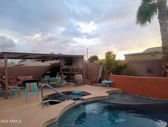 pool with a patio area and a fenced backyard