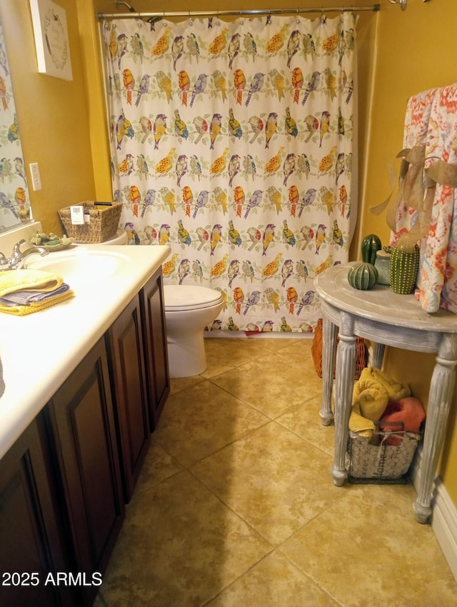 bathroom featuring a shower with shower curtain, toilet, vanity, and tile patterned flooring