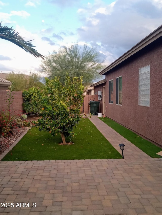 view of yard featuring a patio area and fence