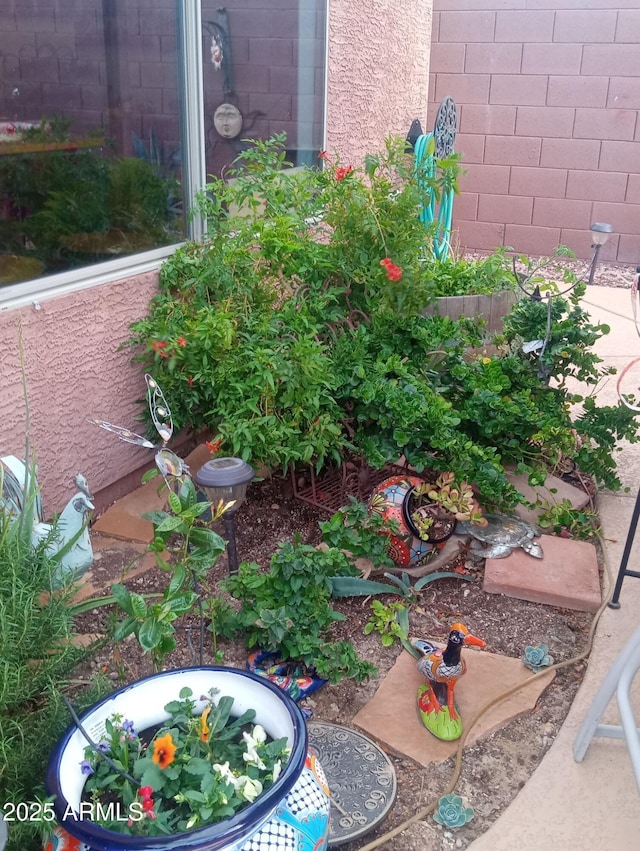 exterior space featuring a garden and fence