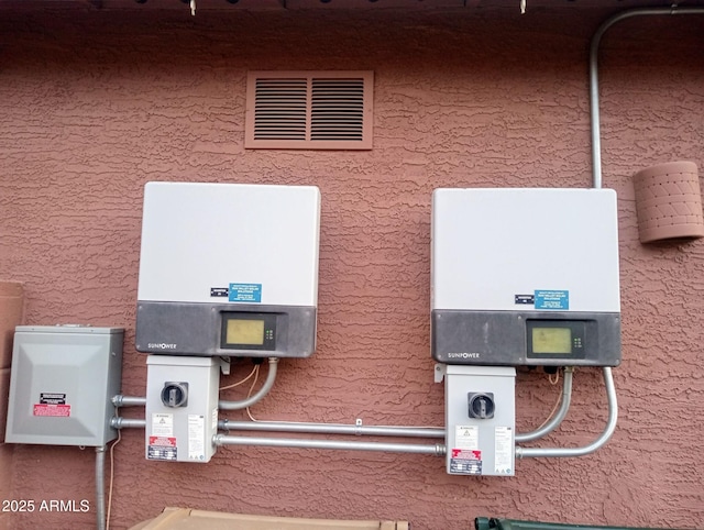 exterior details featuring visible vents and stucco siding