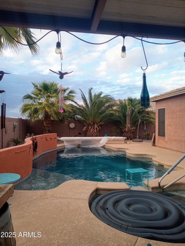 view of pool featuring a patio area, a fenced backyard, and a hot tub