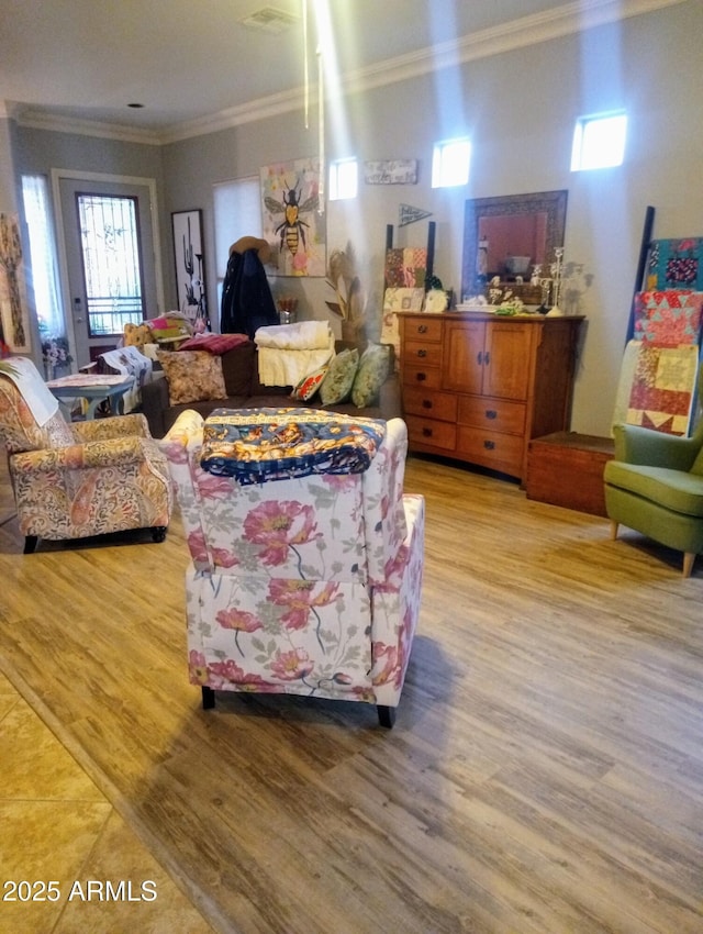 living room featuring light wood-type flooring and ornamental molding