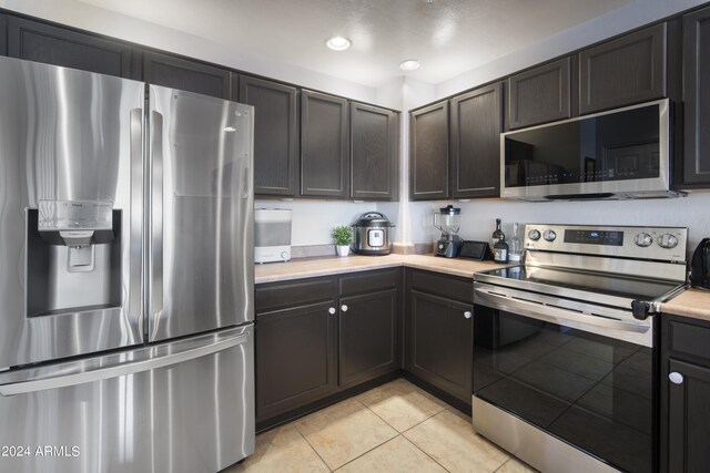 19700 N 76th St Unit 2057, Scottsdale, AZ 85255 - kitchen featuring appliances with stainless steel finishes, light tile patterned flooring, light countertops, and recessed lighting