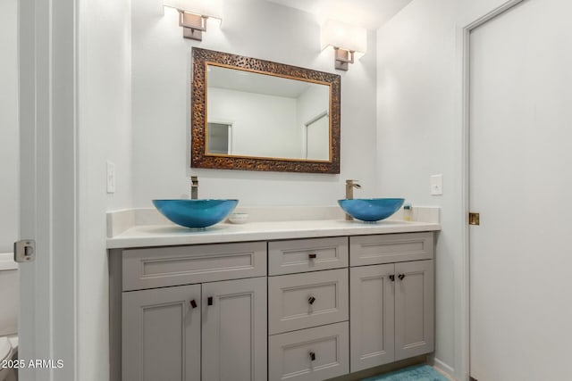 bathroom featuring toilet and vanity