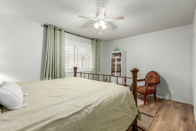 bedroom featuring a textured ceiling, ceiling fan, and hardwood / wood-style flooring