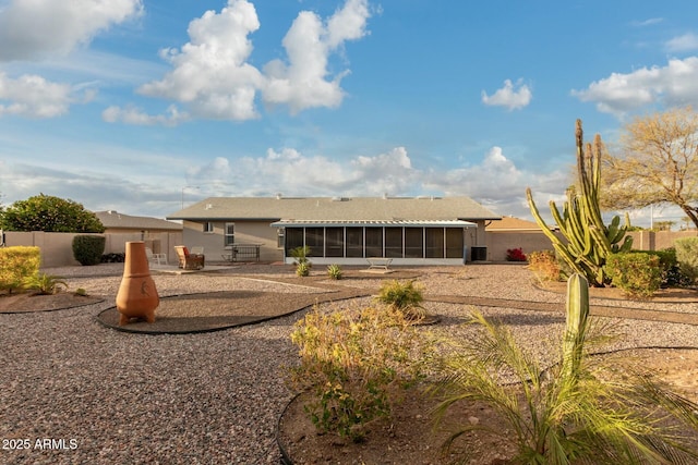 rear view of property featuring a sunroom and a patio