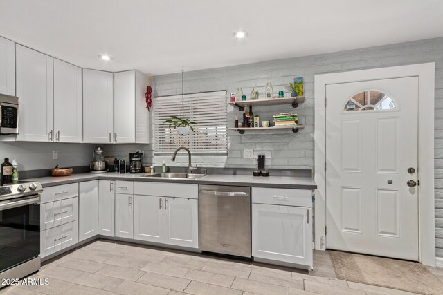 6739 N 16th St Unit 14, Phoenix, AZ 85016 - kitchen featuring appliances with stainless steel finishes, white cabinets, light countertops, light wood-style flooring, and recessed lighting