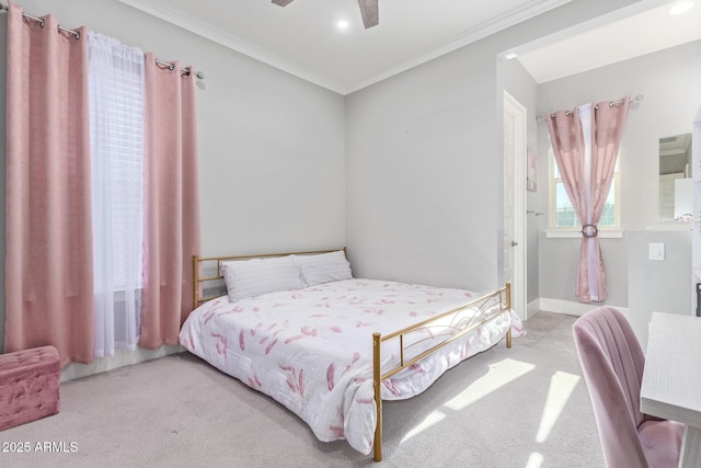 carpeted bedroom with crown molding and ceiling fan